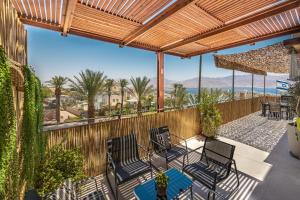 a patio with chairs and a view of the ocean at YANZ APARTMENT in Eilat