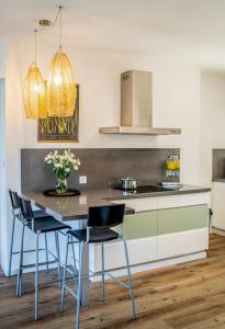 a kitchen with a table with chairs and a counter at Hakochav in Eilat