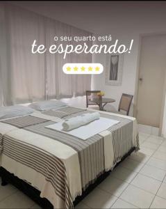 a bedroom with a bed with a sign that reads to argentina at Majestic Hotel in Campina Grande