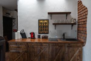 a kitchen with a wooden counter with a sink at Gotyk na dotyk z tarasem na dachu in Toruń