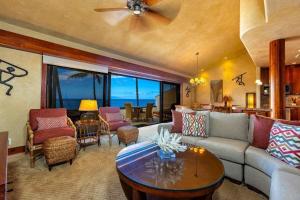 a living room with a couch and a table at MAKENA SURF #B304 condo in Wailea