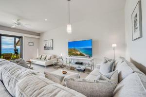 a living room with a couch and a table at MAKENA SURF #F-102 condo in Wailea