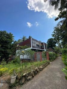 a house on top of a hill with plants at Exotic Backpackers in Banyuwedang