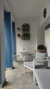 a room with chairs and a table with plants on the wall at Boutique Hotel Ferrara in Ferrara