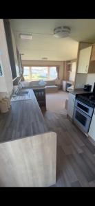 a kitchen with a stove and a counter top at Woods caravan in Ingoldmells