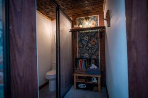 a small bathroom with a toilet and a mirror at La Botanica Hotel in San Juan