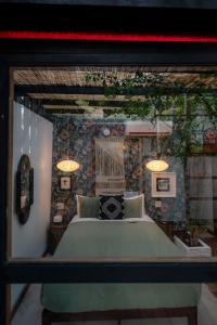 a bedroom with a large bed and two lamps at La Botanica Hotel in San Juan