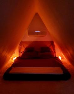 1 dormitorio con 1 cama en una habitación oscura en Modern cottage, views and a jacuzzi, en Pécs