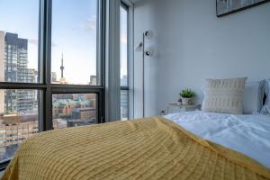 a bedroom with a bed and a large window at Lovely 1 bed in Central Toronto in Toronto