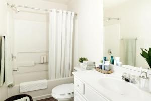 a white bathroom with a toilet and a sink at InTown Suites Extended Stay Orlando FL – Presidents Dr in Orlando