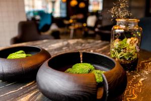 two wooden bowls filled with moss on top of a table at Motel One Edinburgh-Royal in Edinburgh