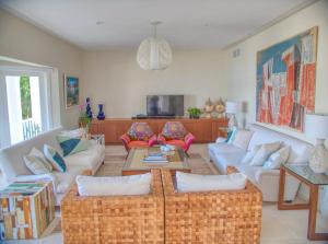 a living room with couches and a table at Sunny Vacation Villa No 48 in San Rafael del Yuma