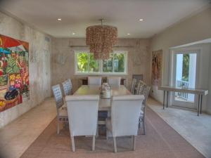 a dining room with a table and chairs and a chandelier at Sunny Vacation Villa No 48 in San Rafael del Yuma