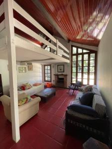 a living room with a loft bed and a couch at Casa linda no sítio in Duque de Caxias