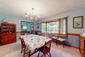 a dining room with a table and chairs at Pine Knoll Nest in Pine Knoll Shores