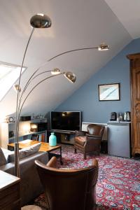 a living room with a couch and a table at Demeure Belle Epoque in Reims