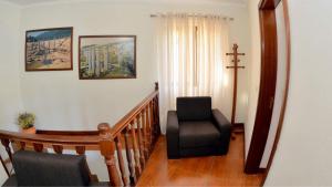 a stairway with a chair and a cross on the wall at Menina do Rio in Rio Caldo