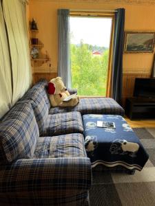 a teddy bear sitting on a bed in a bedroom at House in Røros in Røros