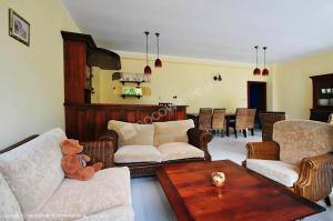 a living room with a teddy bear sitting on a couch at Willa Karolinka in Łeba