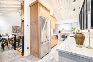 a kitchen with a stainless steel refrigerator and a table at Dune House in Manistee