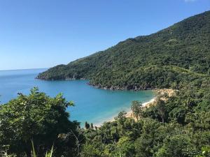 a view of a beach in the middle of a mountain at Chalés da Barra Ilhabela in Ilhabela