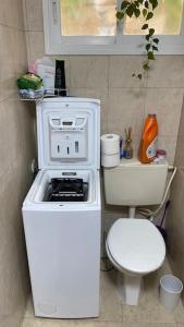 a small kitchen with a stove and a toilet at Sea view apartment in Haifa