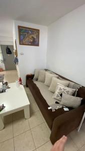 a living room with a couch and a table at Sea view apartment in Haifa