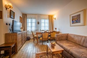 a living room with a couch and a dining room at Four Riders Guest House in Veliko Tŭrnovo