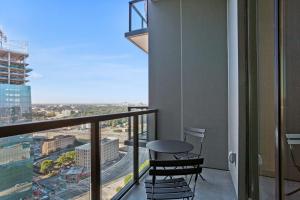 a balcony with two stools and a view of a city at Midtown Luxury Apartment in Atlanta