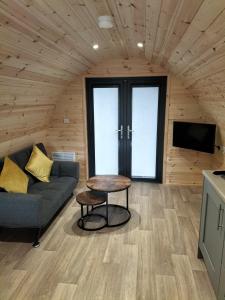 a living room with a couch and a table at Gateway Glamping in Farranfore