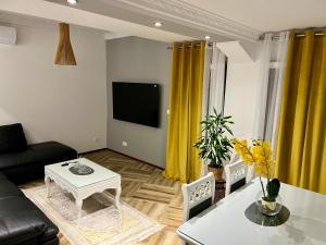 a living room with a couch and a table at Apartman Scepanovic in Nikšić