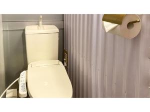 a bathroom with a toilet and a roll of toilet paper at Forte "Hachijojima" - Vacation STAY 62479v in Hachijo