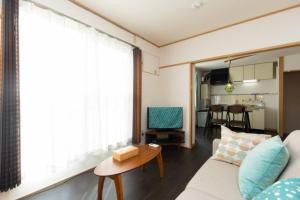 a living room with a couch and a table at Grace Heiwajima - Vacation STAY 15088 in Tokyo