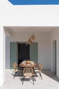 - une salle à manger avec une table et des chaises dans l'établissement Olivine Paros Villas, à Parikia