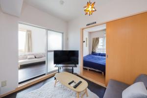 a room with a bed and a chair and a mirror at Grace Heiwajima - Vacation STAY 15089 in Tokyo