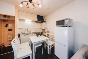 a small kitchen with a table and a refrigerator at Grace Heiwajima - Vacation STAY 15089 in Tokyo