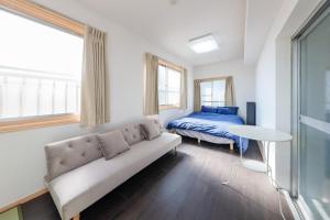 a living room with a couch and a bed at Grace Heiwajima - Vacation STAY 15089 in Tokyo