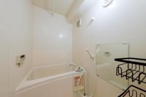 a white bathroom with a shower and a tub at Grace Heiwajima - Vacation STAY 15089 in Tokyo