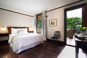 a bedroom with a bed and a sliding glass door at Naramata Inn in Naramata