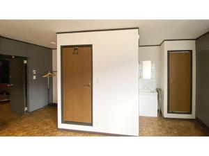 an empty room with two doors and a kitchen at Forte "Hachijojima" - Vacation STAY 62466v in Hachijo