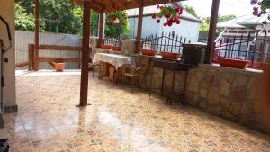 a patio with a table and chairs on a floor at SC Pati-Com FLOREX SRL - CASA ADELA in Tulcea