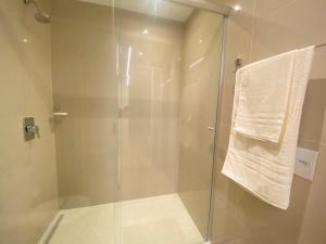 a bathroom with a shower with a glass door at Excelente Apto 1Q St Marista - 453 in Goiânia