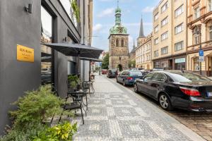 a street with cars parked on the side of the road at numa I Republika Rooms & Apartments in Prague