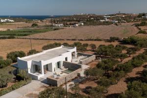 an aerial view of a white house in a field at Olivine Paros Villas in Parikia