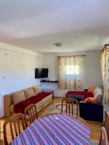 a living room with a couch and a table at Apartmani Bozovic in Žabljak