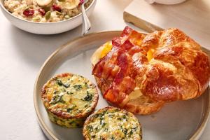 a plate of breakfast food with eggs bacon and toast at SpringHill Suites by Marriott Oklahoma City Quail Springs in Oklahoma City