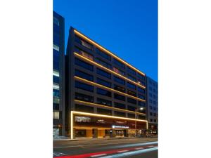 an office building on a city street at night at Torifito Hotel & Pod Kanazawa - Vacation STAY 88232v in Kanazawa
