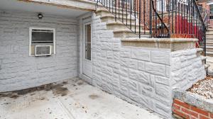 a building with a window and a stair case at 2Beds Apt walking distance to major hospitals - heart of Morris Park - Bronx 30 days plus in Morris Park