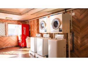a laundry room with a washer and dryer at Hotel AreaOne Minamisoma - Vacation STAY 56242v in Minamisouma