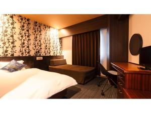 a hotel room with a bed and a desk at Hotel AreaOne Minamisoma - Vacation STAY 56242v in Minamisouma +53 photos